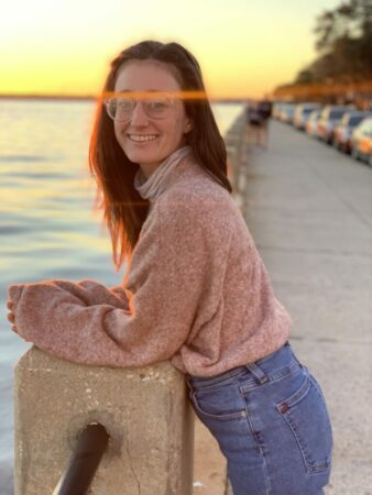posing along waterfront at sunset