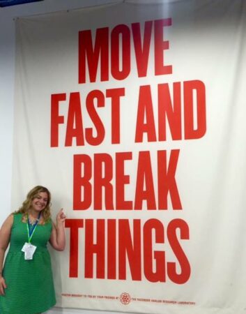 Woman in front of "move fast and break things" banner.