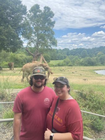 Man and woman in front of elephant and geese habitat.