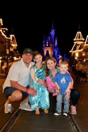Family smiling at Disney World.
