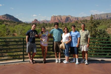 a family photo smiling in front of a canyon.