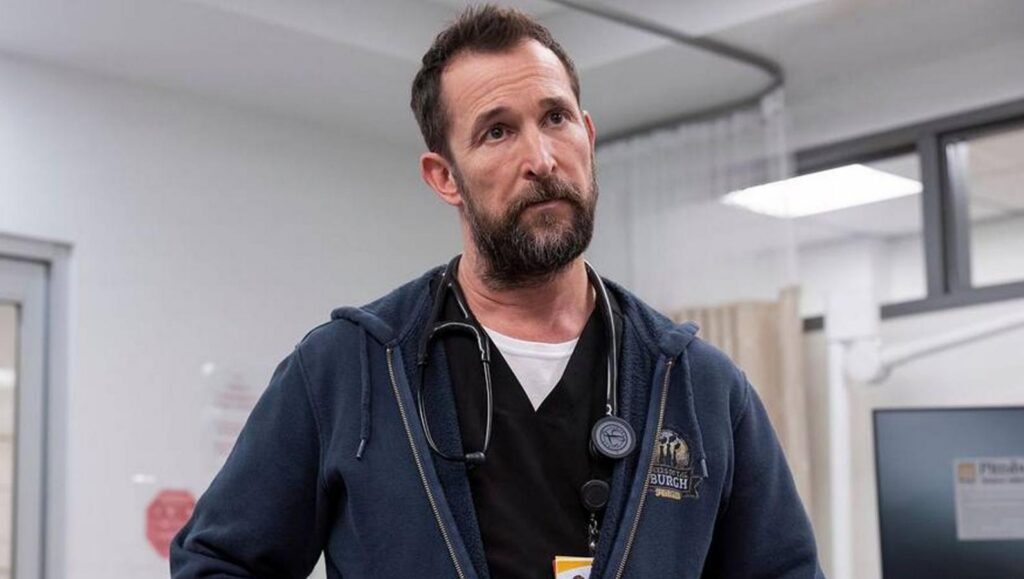 Noah Wyle wearing a stereoscope around his neck